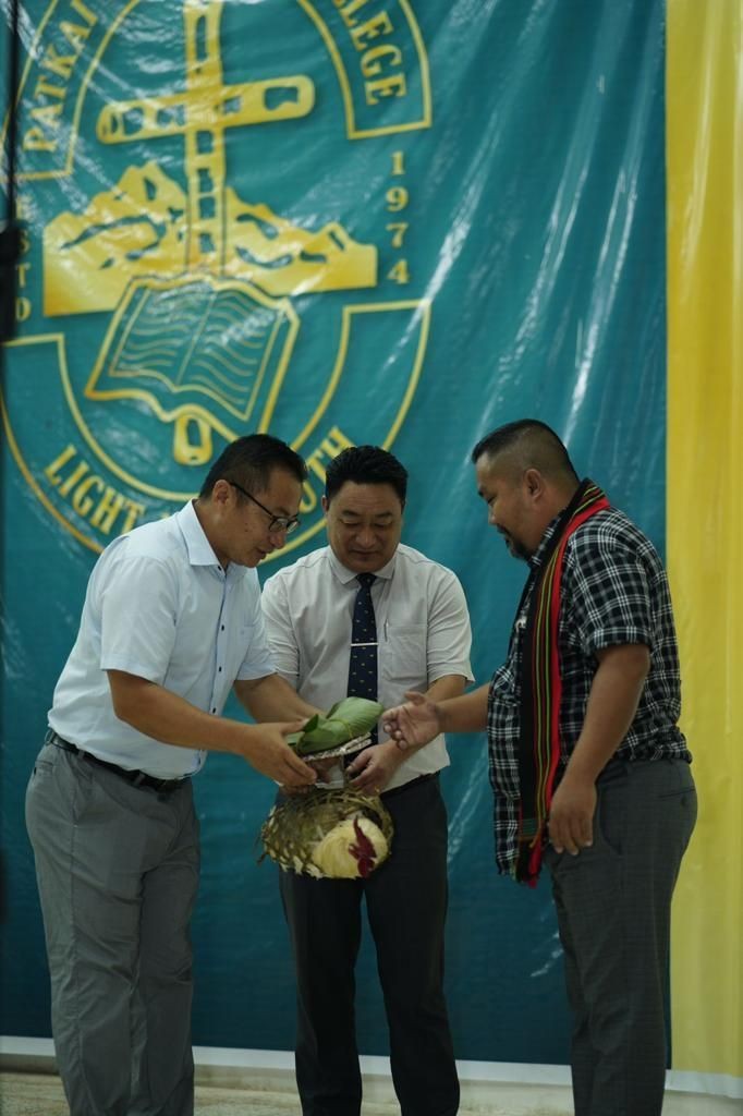 Patkai Christian College (Autonomous) Principal Dr Thepfüvilie Pierü presents the customary handing over a rooster and a kilo of salt to donor villages-Chümoukedima and Seithekema, during the college’s 49th Foundation Day on August 28. (Morung Photo)